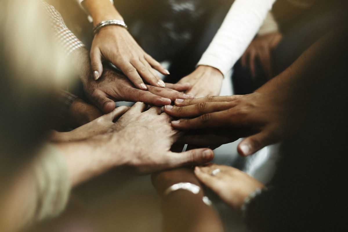 Closeup of diverse people joining their hands